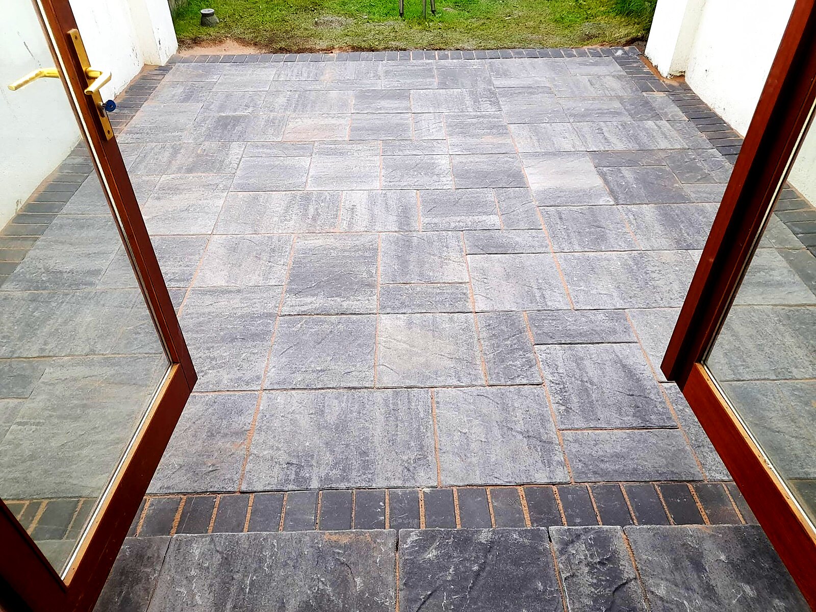 Close view of charcoal paving and dark brick edging
