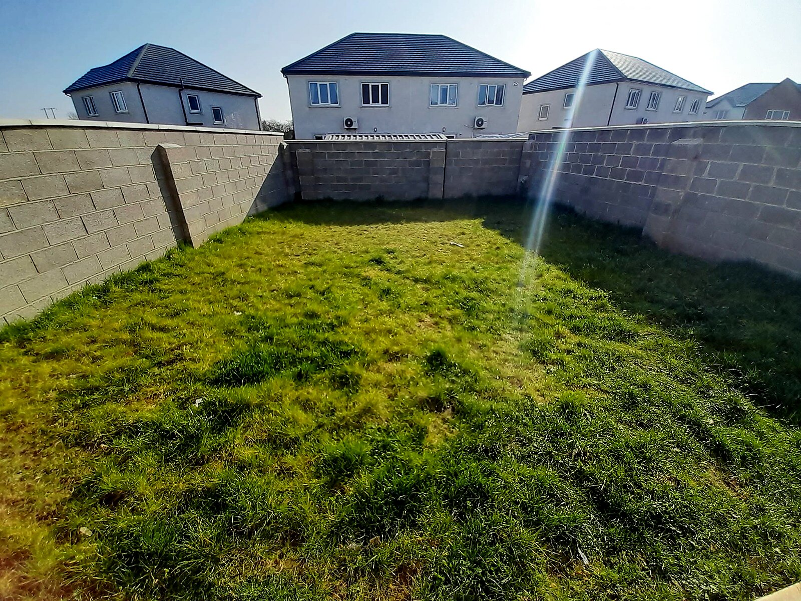 New-build garden before: uneven, patchy grass